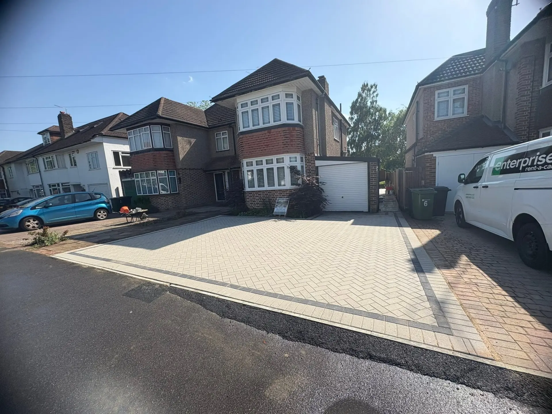 Cream herringbone block paved driveway with charcoal border