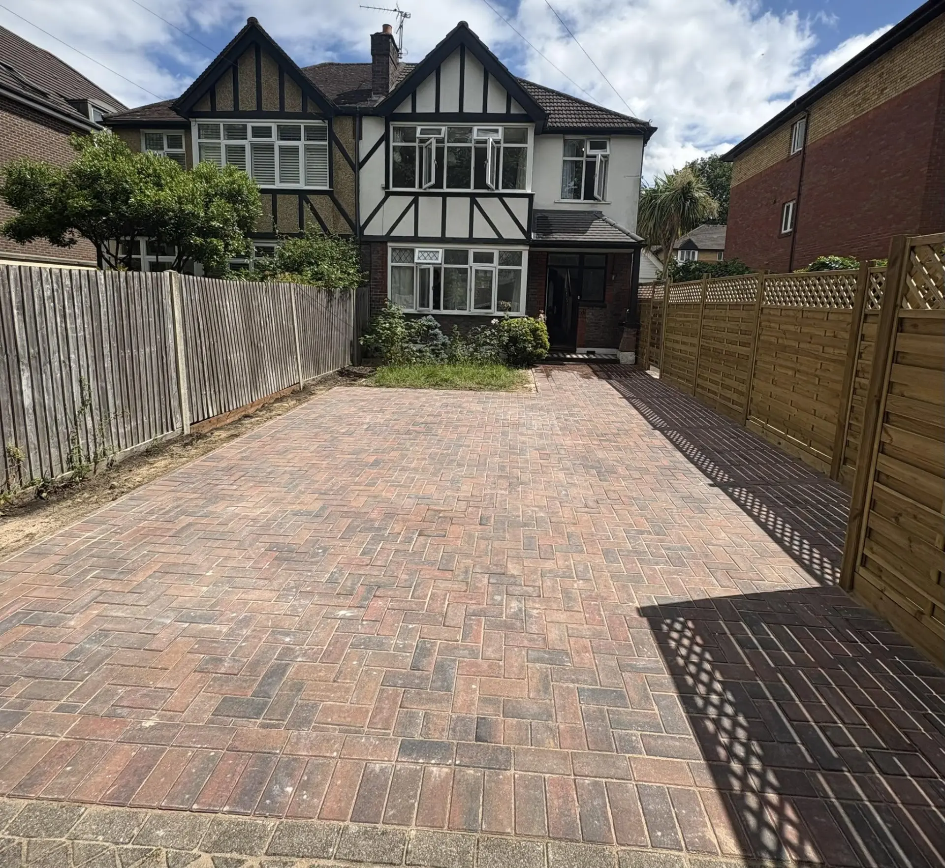 Brindle block paved driveway laid to the front of a Tudor-style home